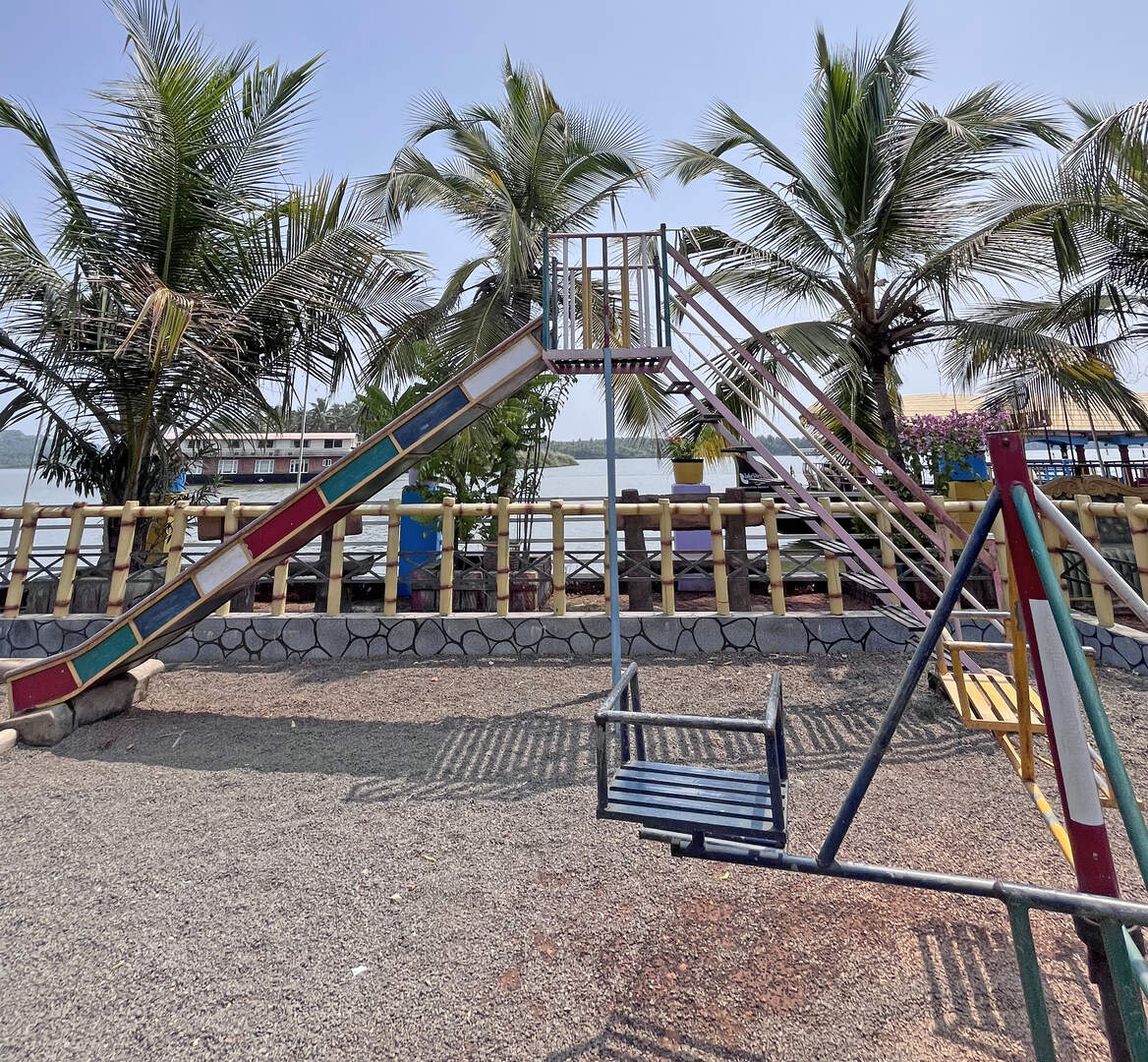Merry-go-round swing and colorful slide at the park